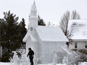 In an annual spectacle delayed this year by warm weather, Don Greer applies a water spray to create an ice sculpture at the Resurrection Lutheran Church on Lenore Drive Friday, December 18, 2015.