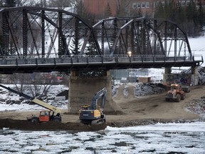 Saskatoon hit a high of -6 C on Monday, making it a little more pleasant for the workers who continue to build an earthen berm under Victoria Bridge as a step in replacing the old bridge.
