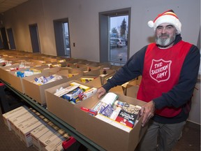 Salvation Army volunteer Calvin Carr helps load food hampers at Confederation Mall Tuesday, December 22, 2015.