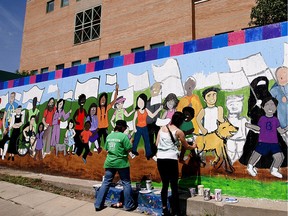 Volunteers and staff from numerous organizations, including SCYAP (Saskatoon Community Youth Arts Programming), painted a mural at St. Paul's Hospital in 2013.