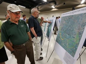 People examine maps of proposals for a Saskatoon freeway during an information session at the German Concordia Club, Thursday, June 25, 2015.