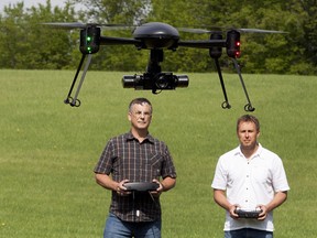 Kevin Lauscher, left, and Zenon Dragan fly a remote controlled Draganfly x4-ES Ultraportable quad copter outside Saskatoon in this file photo.