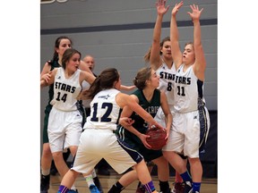 File Photo. Holy Cross Crusaders' Emily Barker hits a wall of Bethlehem Stars defenders during high school girls basketball action at Bethlehem Collegiate, December 1, 2015.