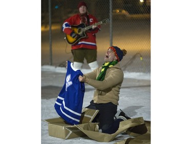 Gaelan Beatty of Sum Theatre, a Canadiens and Maurice Richard fan, reacts to getting a Leafs jersey during a performance on ice at Victoria School of the Canadian classic The Hockey Sweater as part of the Winterlude festival, December 3, 2015. The event runs to December 5.