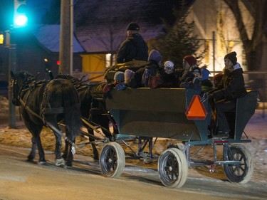 People get a horse-drawn wagon ride at Victoria School as part of the Winterlude festival, December 3, 2015. The event runs to December 5.