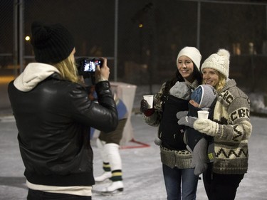 People pose for photos on the ice at Victoria School prior to a performance of the Canadian classic The Hockey Sweater as part of the Winterlude festival, December 3, 2015. The event runs to December 5.
