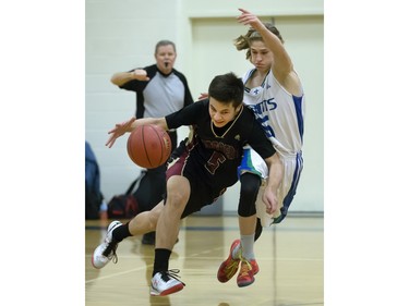 Centennial Chargers' Jeff Erickson (L) tries to advance the ball against the tough defence of Bishop James Mahoney defender Brant Morrow during action in the Bowlt Classic at Evan Hardy Collegiate, December 3, 2015.