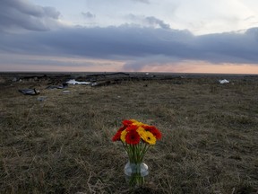 A vase of flowers sits at the site of a crash where three Carrot River teenagers were killed when their vehicle was struck by a semi on Sunday afternoon on Highway 6 on May 3, 2015.