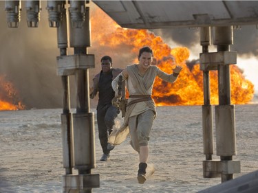 Daisy Ridley as Rey (R) and John Boyega as Finn in "Star Wars: The Force Awakens," directed by J.J. Abrams.
