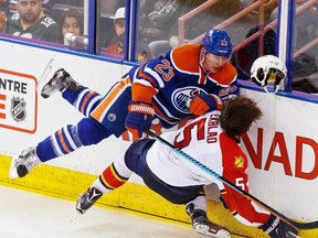 Edmonton Oilers forward Matt Hendricks (top) crashes into Florida Panthers defenceman Aaron Ekblad during the third period of their NHL game at Rexall Place in Edmonton on Sunday, Jan. 10, 2016.