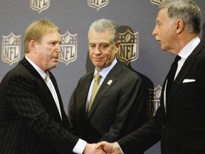 Oakland Raiders owner Mark Davis (left) shakes hands with St. Louis Rams owner Stan Kroenke (right) as Pittsburgh Steelers president Art Rooney II looks on after an NFL owners meeting on Tuesday, Jan. 12, 2016, in Houston. The owners voted to allow the Rams to move to a new stadium just outside Los Angeles, and the San Diego Chargers will have an option to share the facility.