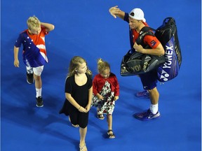 Lleyton Hewitt of Australia waves goodbye to the crowd as he leaves the stadium with his kids after losing his second-round match against David Ferrer at the 2016 Australian Open at Melbourne Park on January 21, 2016 in Melbourne, Australia.