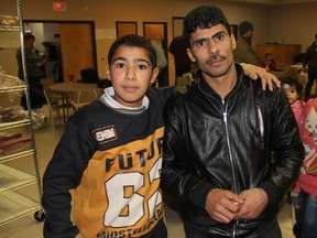 Abdul Hanan Khalyan, left, can be seen with his father Fares Khalyan at an orientation session for Syrian refugees who recently arrived in Saskatoon at the Westend Community Centre. At the event, participants were given information on services provided by the Saskatoon Open Door Society, but they also got a crash course on Canadian culture.