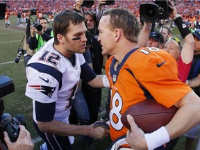 Tom Brady (left) of the New England Patriots congratulates Peyton Manning of the Denver Broncos on Jan. 19, 2014 in Denver, Colorado.
