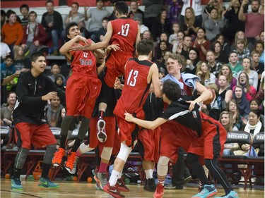 The Bedford Road Collegiate RedHawks celebrate a 53-52 win over the Holy Cross Crusaders during the annual BRIT basketball classic  Friday, January 08, 2016.