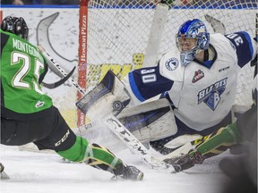 Saskatoon Blades goalie Brock Hamm makes a blocker save against Prince Albert Raiders forward Sean Montgomery in second period WHL action on Friday, January 1st, 2016.