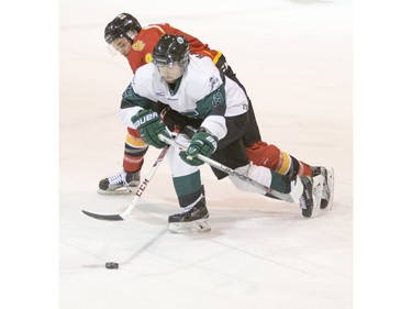 University of Saskatchewan forward  Kohl Bauml moves the puck against the University of Calgary Dinos in CIS men's hockey action, January 16, 2016.