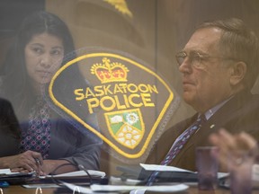 New chair of the Saskatoon board of police commissioners, Darlene Brander, left, and Saskatoon Mayor Don Atchison are seen in this triple exposure with a Saskatoon police crest during a board meeting at city hall Thursday. Brander replaces Atchison, who has been chair since 2003.
