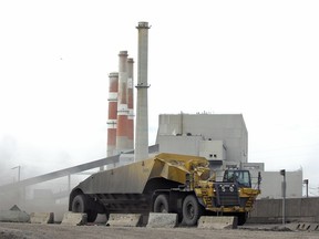 A coal hauler drives past SaskPower's Boundary Dam Power Station.