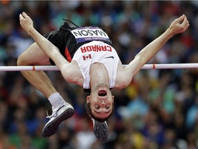 Canada's Michael Mason clears the bar in the men's high jump final during the athletics in the Olympic Stadium at the 2012 Summer Olympics.