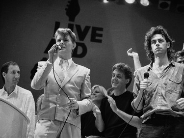 Saturday, July 13, 1985: David Bowie, front left, and Bob Geldof, right right, at the end of the London part of the Live Aid famine relief concert at Wembley Stadium in London.