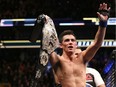 Dominick Cruz celebrates after regaining the Ultimate Fighting Championship bantamweight title with a win over TJ Dillashaw on Jan. 17, 2016, in Boston.