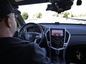 Virginia Tech Center for Technology Development Program administration specialist Greg Brown behind the wheel of a driverless car during a test ride.