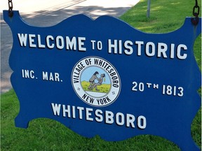 In this photo taken July 16, 2015, a welcome sign on the village green, Whitesboro, N.Y., displays the village seal. Whitesboro will let voters decide whether to keep the longtime village seal that has been called offensive to Native Americans.
