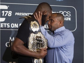 In this Aug. 4, 2014, file photo, challenger Daniel Cormier, right, prepares to shove UFC light heavyweight champion Jon Jones during a mixed martial arts press conference at the MGM Grand in Las Vegas.