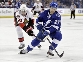 Tampa Bay Lightning left wing Jonathan Drouin (27) loses the puck to a stick-check by Ottawa Senators center Mika Zibanejad (93), of Sweden, during the first period of an NHL hockey game Thursday, Dec. 10, 2015, in Tampa, Fla. The agent for Drouin said Sunday that he made a trade request with the Lightning over a month ago.