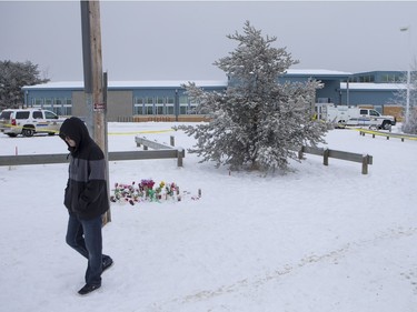 A boy leaves the memorial outside of La Loche Community School as RCMP continue to control the scene on January 24, 2016.