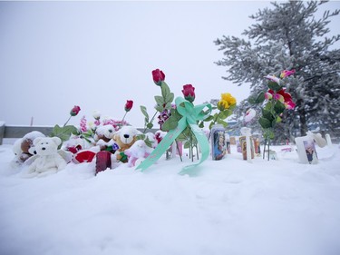 A memorial just outside of the school grounds still sits after Friday's school shooting at La Loche Community School on Sunday, January 24, 2016.