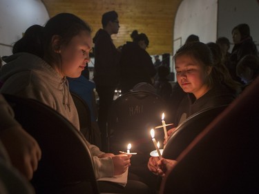 Talya Montgrand, left, Nellie Piche and more than 200 others took in a candlelight vigil at the La Loche community hall on January 24, 2016 for Friday's shooting victims, as well as the dozens of residents who've committed suicide in recent years.