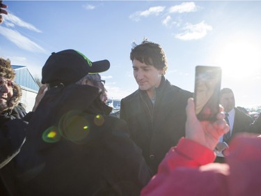 Prime Minister Justin Trudeau is greeted by people from La Loche after arriving at the airport on January 29, 2016.