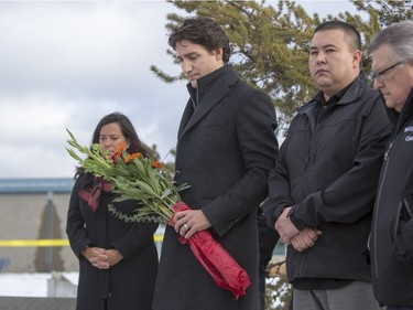 Prime Minister Justin Trudeau lays flowers at a memorial at La Loche Community School on January 29, 2016.