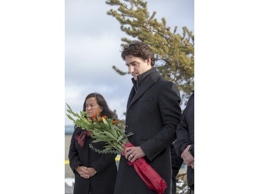 Prime Minister Justin Trudeau lays flowers at a memorial at La Loche Community School on January 29, 2016.