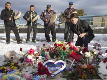 Prime Minister Justin Trudeau lays flowers at a memorial at La Loche Community School on January 29, 2016.