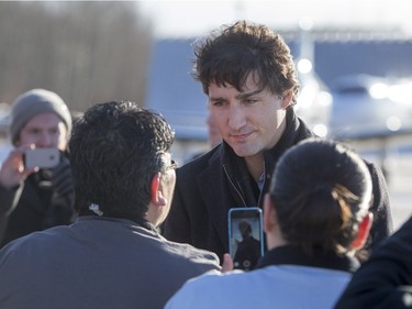 Prime Minister Justin Trudeau is greeted by people from La Loche after arriving at the airport on January 29, 2016.