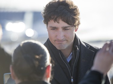 Prime Minister Justin Trudeau is greeted by people from La Loche after arriving at the airport on January 29, 2016.