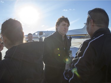 Prime Minister Justin Trudeau is greeted by people from La Loche after arriving at the airport on January 29, 2016.