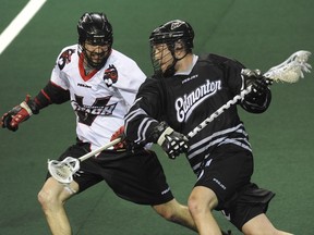 Vancouver Stealth Matt Beers tries to stop Edmonton Rush Mark Matthews in lacrosse action at Langley Events Centre Saturday, January 25, 2014.