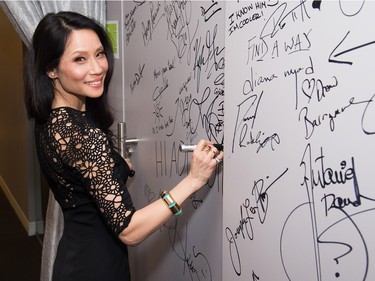 Lucy Liu signs the wall at AOL Studios after participating in AOL's BUILD Speaker Series to discuss the upcoming film "Kung Fu Panda 3," January 26, 2016, in New York.