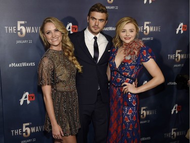 L-R: Maika Monroe, Alex Roe, and Chloë Grace Moretz pose together at a special screening of "The 5th Wave" on January 14, 2016 in Los Angeles, California.