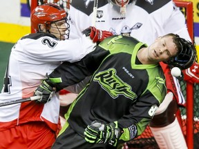 Scott Carnegie of the Calgary Roughnecks gets some retaliation on Zack Greer of the Saskatchewan Rush after a scuffle during NLL action in Calgary on Jan. 2.