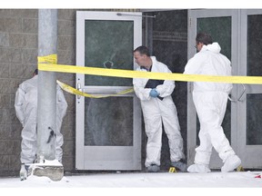 Police investigate the scene on Saturday, January 23, 2016 of a Friday shooting at a school in La Loche Sask. The shooting left four people dead.