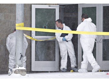 Police investigate the scene on January 23, 2016 of a Friday shooting at a school in La Loche. The shooting left four people dead.