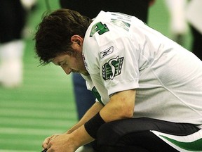 Saskatchewan Roughriders' kicker Paul McCallum crouches on the sideline after missing a decisive kick in the CFL's 2004 Western Division Championship game to the B.C. Lions