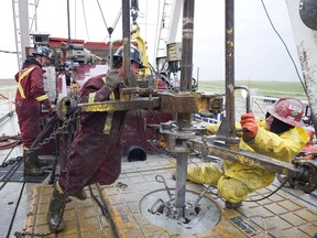 Workers on a drilling rig on a oil well in near Weyburn. The price of oil isn't expected to crest $50 until the end of 2017, according to the Conference Board of Canada.