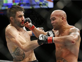 Robbie Lawler, right, fights Carlos Condit during a welterweight championship mixed martial arts bout at UFC 195, Saturday, Jan. 2, 2016, in Las Vegas.