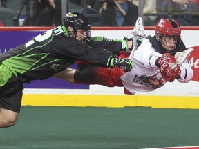 Curtis Dickson of the Calgary Roughnecks lunges for the Saskatchewan Rush net ahead of Adrian Sorichetti during their Jan. 2 home opener.